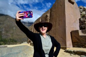 A girl taking a selfie near a monument